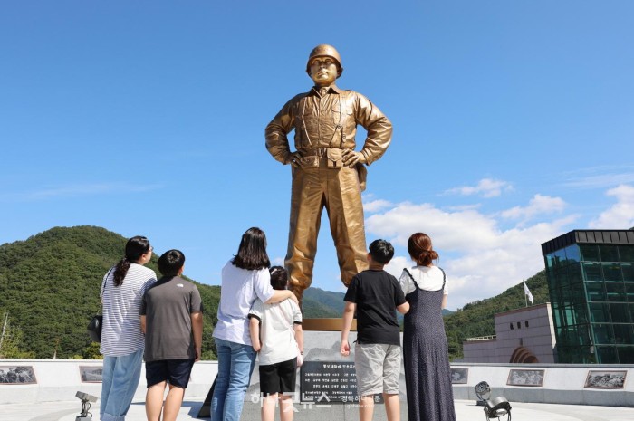 지난 12일 다부동전적기념관을 찾은 가족 단위 관람객이 백선엽 장군 동상을 바라보고 있다..JPG